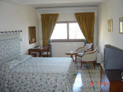Una cama o camas en una habitación de Hotel Rufolo