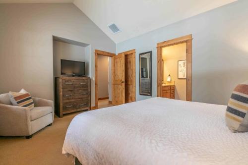 a bedroom with a large bed and a television at Fairway Drive 13113 by East West Hospitality in Truckee