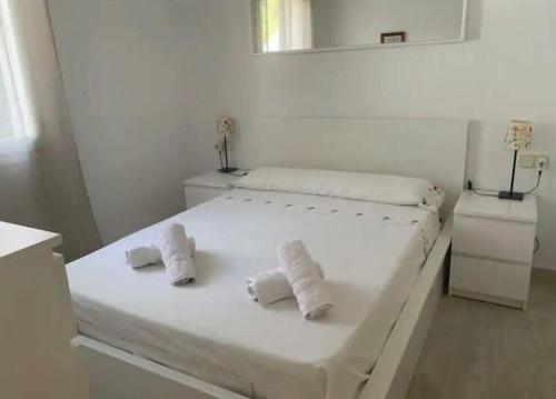 a white bedroom with a bed with towels on it at Son Parc - Albatros in Son Parc