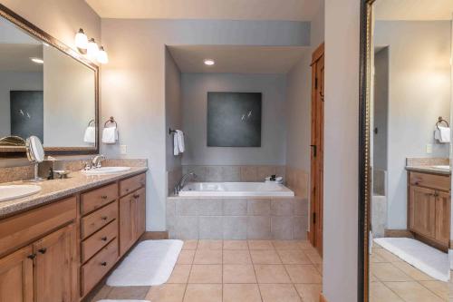 a bathroom with two sinks and a bath tub at Fairway Drive 13113 by East West Hospitality in Truckee
