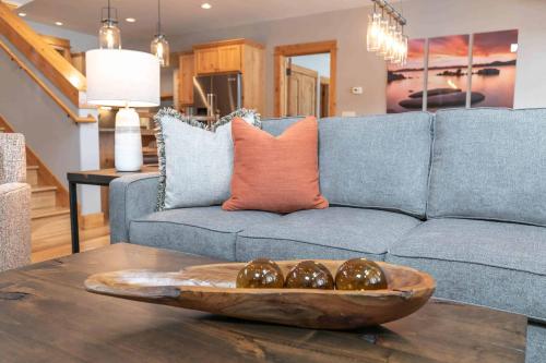 a living room with a couch and a bowl on a table at Fairway Drive 13113 by East West Hospitality in Truckee