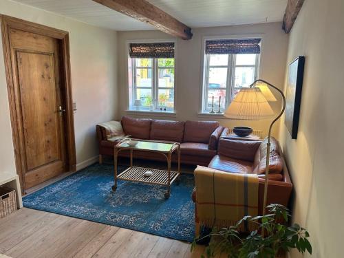 a living room with a couch and a table at I hjertet af Tønder by in Tønder