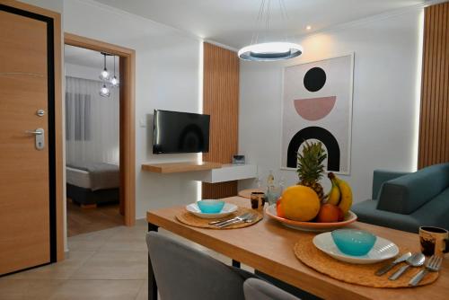 a living room with a table with fruit on it at Mouson Luxury Apartment in Kavala