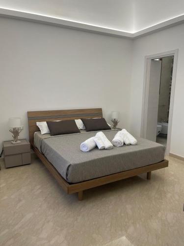 a bedroom with a bed with two towels on it at Olea in Castelluzzo