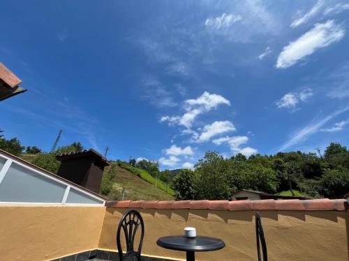 a table and chairs on a balcony with a blue sky at Hotel Larrañaga in Azpeitia