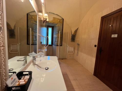 a bathroom with a sink and a large mirror at Hotel Larrañaga in Azpeitia