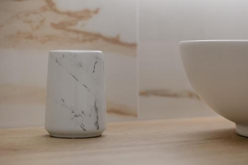 a white vase sitting on top of a wooden table at King's Rooms in Termoli