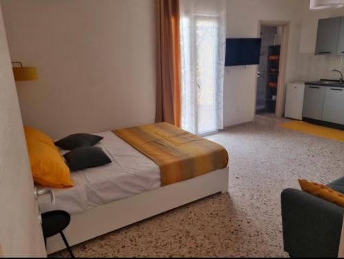 a bedroom with a bed with yellow pillows at Il Tramonto Dorato in Carini