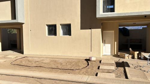 a fire hydrant sitting on the side of a house at Cabañas Balcón del Famatina in Chilecito