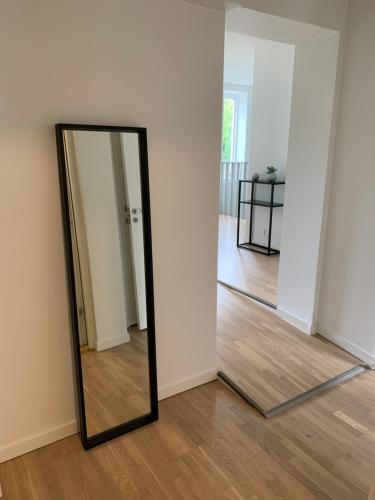 a mirror sitting on the floor in a room at VillaNova in Lund
