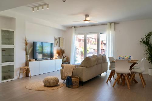 a living room with a couch and a table at Playa Granada Apartamentos Moriscos II in Motril