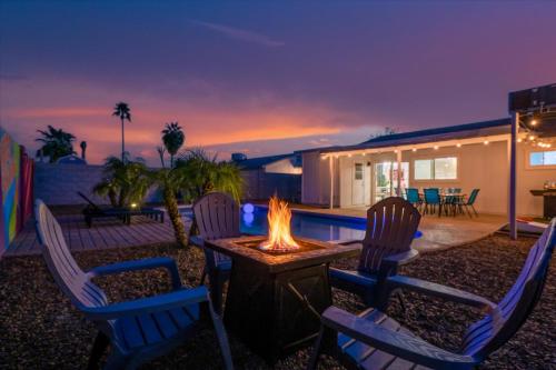 a backyard with two chairs and a fire pit at Mini Golf Fire Pit Pool Game Room in Chandler