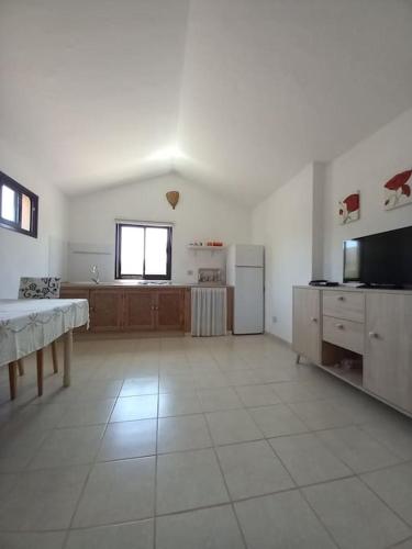 a large white room with a kitchen and a table at descanso en espacio natural con vistasTharada in El Roque