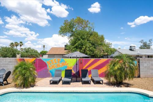 a group of chairs next to a swimming pool at Mini Golf Fire Pit Pool Game Room in Chandler