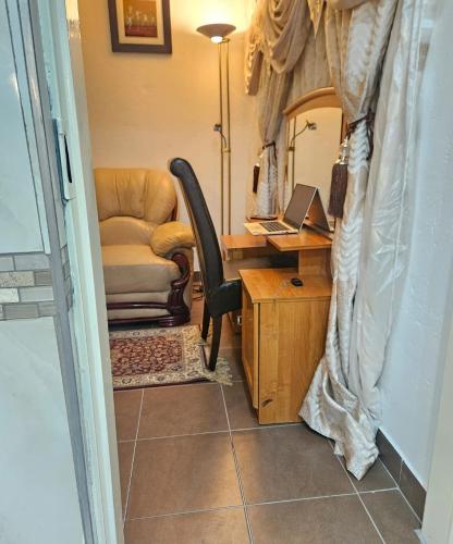 a room with a desk and a chair and a desk with a laptop at The Royal Princess B&B on Malibongwe Drive in Johannesburg