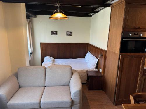 a living room with a couch and a bed at 7 Pools SPA Boutique Hotel in Bansko