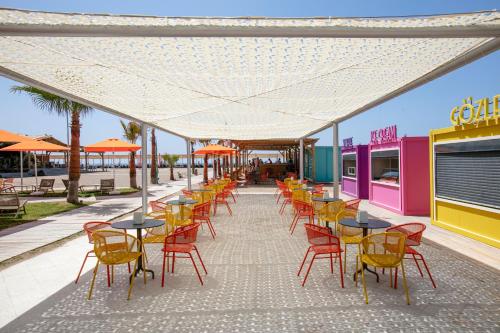 a row of tables and chairs under a white canopy at Megasaray Resort Side in Side