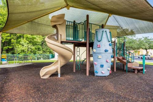 a playground with a slide in a park at Your Home Away from Home! in Kissimmee