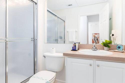a bathroom with a toilet and a sink and a shower at Your Home Away from Home! in Kissimmee