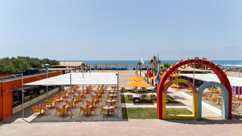 a group of tables and chairs next to the beach at Megasaray Resort Side in Side