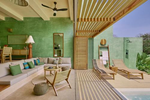 an outdoor living room with a couch and chairs at Punta Nayaá - Adults Only in Puerto Escondido