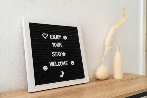 a picture of a sign on a shelf with a vase at Your Home Away from Home! in Kissimmee