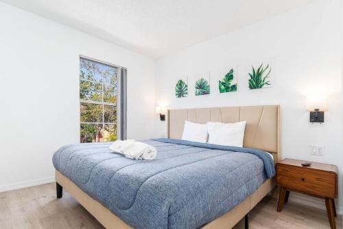 a bedroom with a large bed with a blue blanket at Your Home Away from Home! in Kissimmee