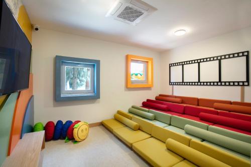 a waiting room with a couch and a tv at Megasaray Resort Side in Side