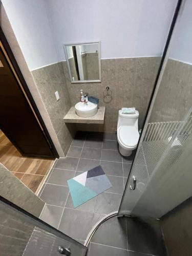 a bathroom with a sink and a toilet at Casa de Huespedes Real 2 in San Pablo Villa de Mitla