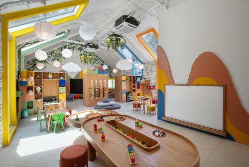 a childrens play room with a table and a train at Megasaray Resort Side in Side