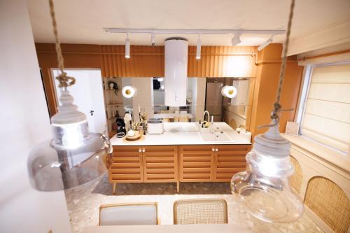a large kitchen with a sink and a mirror at Bear's Apartment Suite Alba Iulia in Alba Iulia