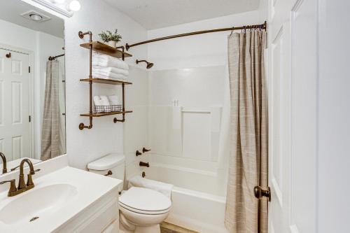 a white bathroom with a toilet and a sink at Van Vacation Retreat with Private 300-Acre Lake! in Van