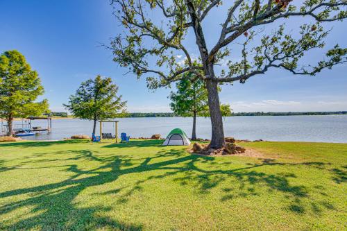 a tent under a tree next to a lake at Van Vacation Retreat with Private 300-Acre Lake! in Van