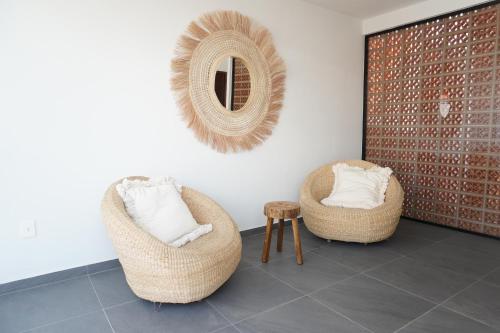a room with two chairs and a mirror on the wall at Casa Martina Guest House in Pátzcuaro