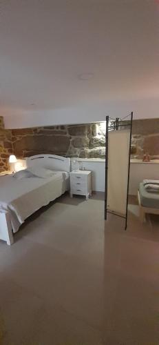 a bedroom with a bed in a room with a window at Hostal Casa Martinez in Bueu
