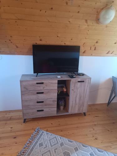 a wooden entertainment center with a flat screen tv on it at Durmitorski cvijet in Žabljak