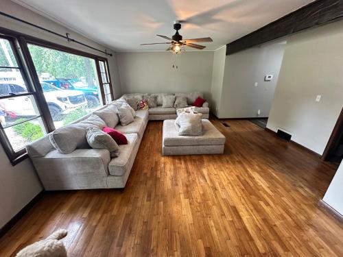 a living room with a couch and a ceiling fan at Cozy on Campus in Lawrence