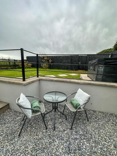 two chairs and a table on a balcony at The Hideaway - Luxury Country Retreat in The Trench