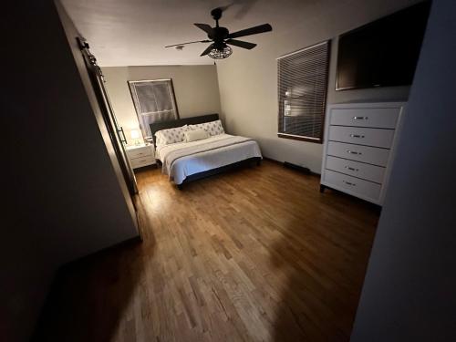 a bedroom with a bed and a ceiling fan at Cozy on Campus in Lawrence