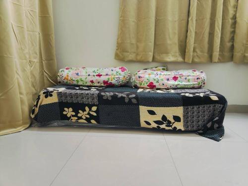 three pillows sitting on a table in a room at Pet Friendly Studio Apartment in Hadapsar in Pune