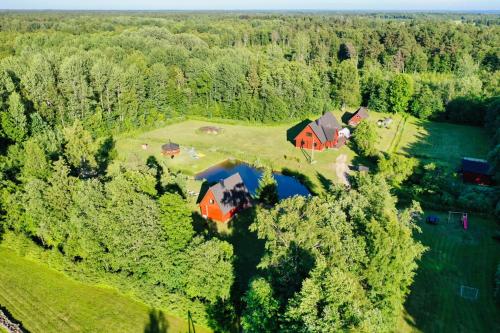 an aerial view of a large house in the forest at Holidayhouse with sauna and pond Leesoja puhkemaja in Ranniku