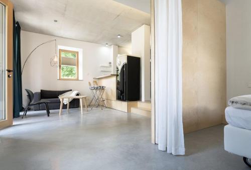 a living room with a couch and a table at Modernes Wohnen am Dorfplatz in Bad Saulgau