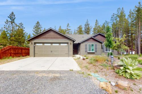 a house with a garage and a driveway at The Riverhouse in Sunriver