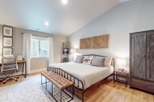 a bedroom with a bed and a desk and a chair at The Riverhouse in Sunriver