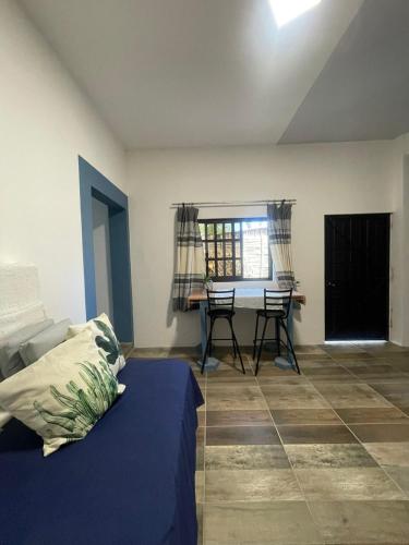 a bedroom with a bed and a table and chairs at Casa de Huespedes Real 2 in San Pablo Villa de Mitla