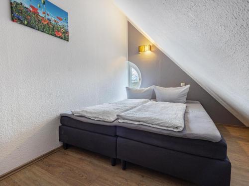 a small bed in a room under the stairs at Studio in Buchholz am Müritzsee in Buchholz