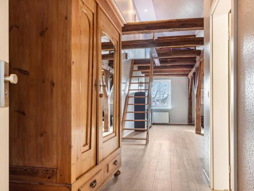 a hallway with a wooden cabinet and a ladder at Ferienwohnung in Buchholz an der Müritz in Buchholz
