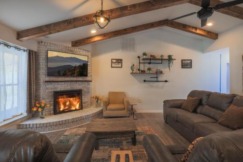 a living room with a couch and a fireplace at Relaxing 3BR Cottage 1 mile to Main st attractions Views in Gatlinburg