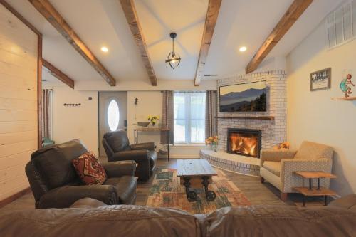 a living room with a couch and a fireplace at Relaxing 3BR Cottage 1 mile to Main st attractions Views in Gatlinburg