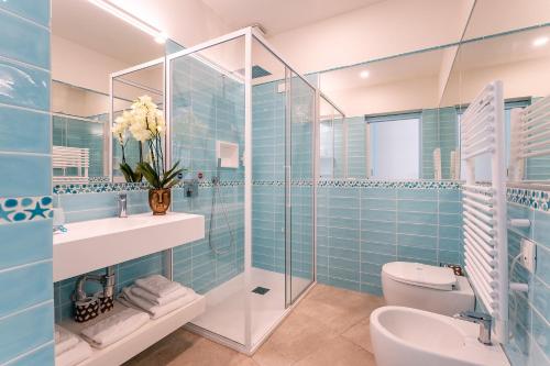 a bathroom with a toilet and a sink and a shower at Oasi Blu Sardinia in Santa Margherita di Pula